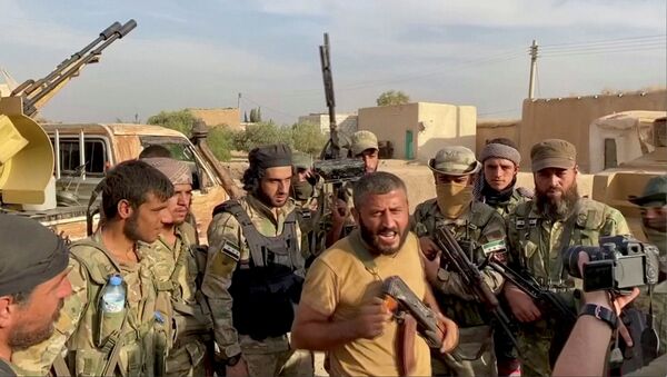 A Syrian rebel fighter declares the liberation of Mehrabli village from the Syrian Democratic Forces (SDF) near Tal Abyad, Syria, October 11, 2019, in this still image obtained from video - Sputnik International