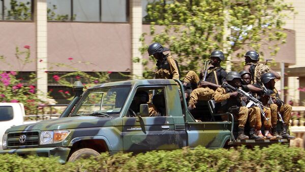 Troops ride in a vehicle near the French Embassy in central Ouagadougou, Burkina Faso - Sputnik International