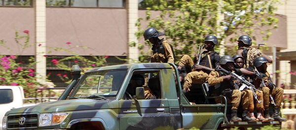 Troops ride in a vehicle near the French Embassy in central Ouagadougou, Burkina Faso - Sputnik International