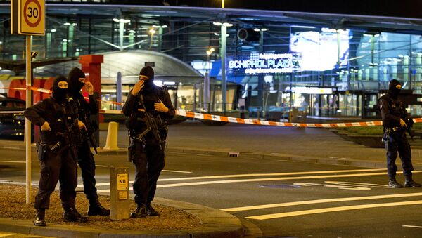 Hooded security forces guard a part of Schiphol Aiport in Amsterdam, Netherlands - Sputnik International