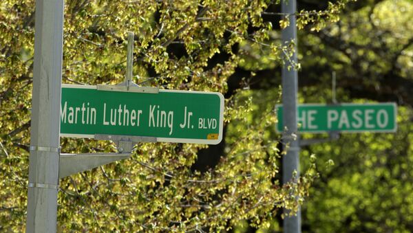 A newly changed sign for Dr. Martin Luther King, Jr. Boulevard stands in contrast to a yet-to-be changed sign for The Paseo in Kansas City - Sputnik International