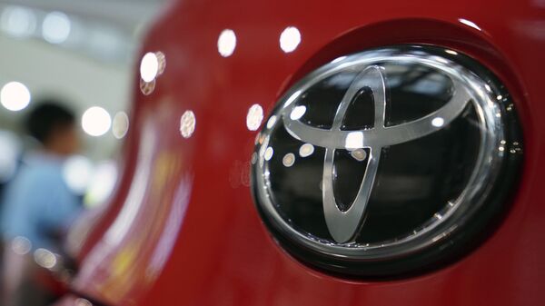 FILE - In this Aug. 2, 2019, file, photo, people walk by the logo of Toyota at a show room in Tokyo - Sputnik International