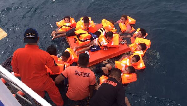 This handout photo taken and released on November 7, 2019 by the Philippine Coast Guard shows passengers of the ill-fated MV Siargao Princess ferry after being rescued from the waters off Sibunga Cebu in the central Philippines. - Philippine authorities launched a rescue operation on November 7 after a ferry with at least 60 people onboard capsized in rough seas, the coast guard said. (Photo by Handout / Philippine coast Guard (PCG) / AFP) /  - Sputnik International