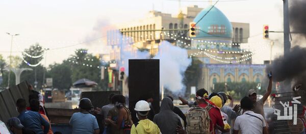 Iraqi riot police fire tear gas to disperse anti-government protesters during ongoing protests in central Baghdad, Iraq, Saturday, Nov. 9, 2019. Mass protests erupted in Baghdad and across southern Iraq last month, calling for the overhaul of the political system established after the 2003 U.S.-led invasion. - Sputnik International