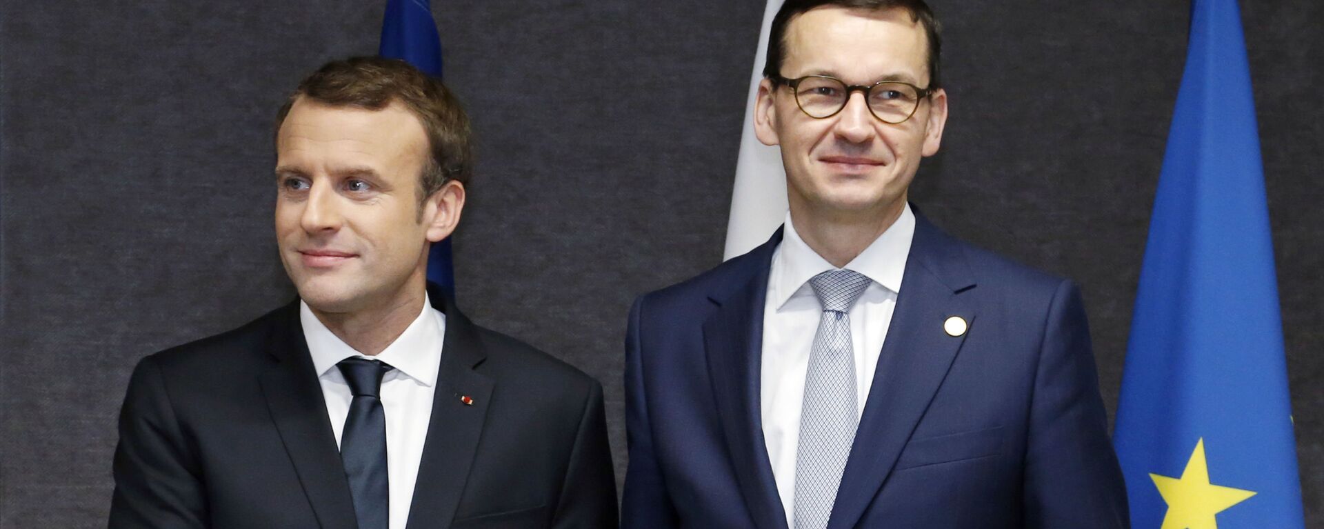 French President Emmanuel Macron, left, shakes hands with Polish Prime Minister Mateusz Morawiecki prior to a meeting on the sidelines of an EU summit in Brussels on Friday, Dec. 15, 2017.  - Sputnik International, 1920, 08.04.2022