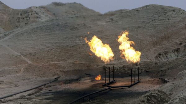 Gas flares burn near an oil well on the outskirts of Masjed Soleiman, a city where some of the first modern oil wells were discovered and drilled in the Middle East, in Khuzestan province, some 725 kilometers (435 miles) southwest of the Iranian capital, Tehran, Wednesday, Nov. 21, 2007. - Sputnik International