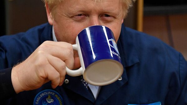 Britain's Prime Minister Boris Johnson reacts as he drinks a cup of tea during a general election campaign visit to the Tetley Tea Factory at Tata Global Beverages in Stockton-on-Tees, Britain November 7, 2019 - Sputnik International
