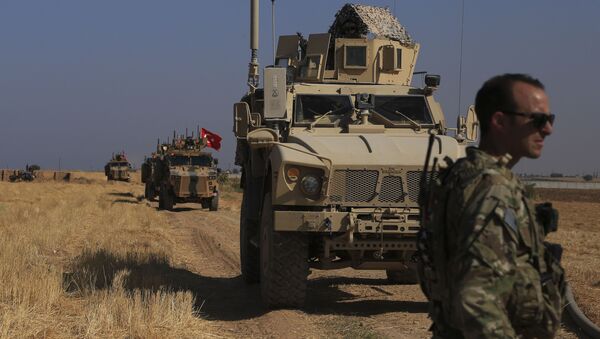 FILE - This Friday, Oct. 4, 2019 file photo, Turkish and American armored vehicles patrol as they conduct joint ground patrol in the so-called safe zone on the Syrian side of the border with Turkey, near the town of Tal Abyad, northeastern Syria - Sputnik International