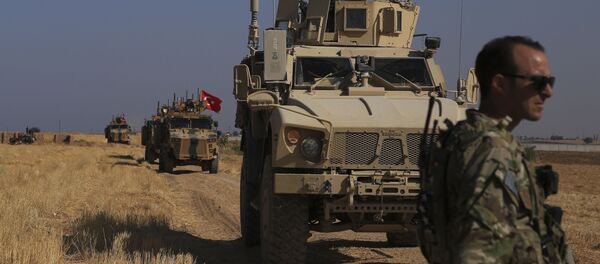 FILE - This Friday, Oct. 4, 2019 file photo, Turkish and American armored vehicles patrol as they conduct joint ground patrol in the so-called safe zone on the Syrian side of the border with Turkey, near the town of Tal Abyad, northeastern Syria FILE - This Friday, Oct. 4, 2019 file photo, Turkish and American armored vehicles patrol as they conduct joint ground patrol in the so-called safe zone on the Syrian side of the border with Turkey, near the town of Tal Abyad, northeastern Syria - Sputnik International