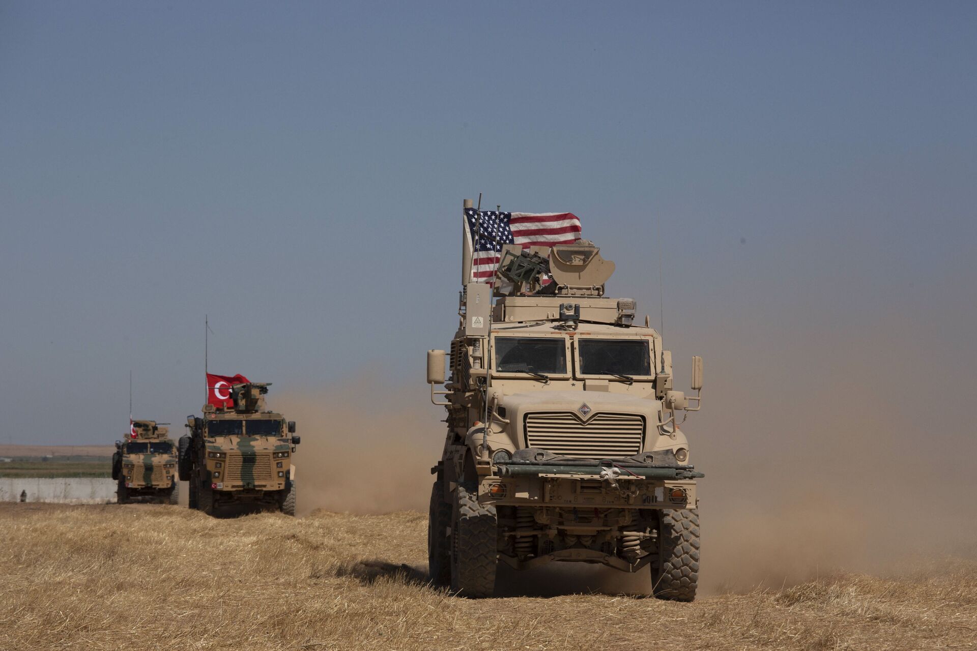 In this Sept. 8, 2019, photo, Turkish and American armored vehicles conduct the first joint patrol in the so-called safe zone on the Syrian side of the border with Turkey near Tal Abyad, Syria - Sputnik International, 1920, 08.07.2022
