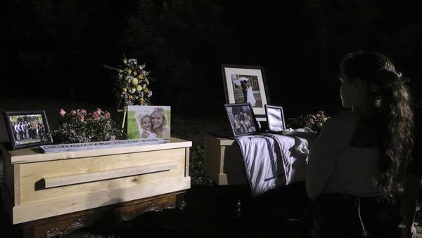 A young girl looks at the coffins with the remains of Rhonita Miller and four of her children, who were among the nine victims killed on November 4 in an attack authorities have blamed on a drug cartel, on their way to their burial at the cemetery of La Mora Ranch in the municipality of Bavispe, Sonora State, Mexico, on November 7, 2019 - Sputnik International