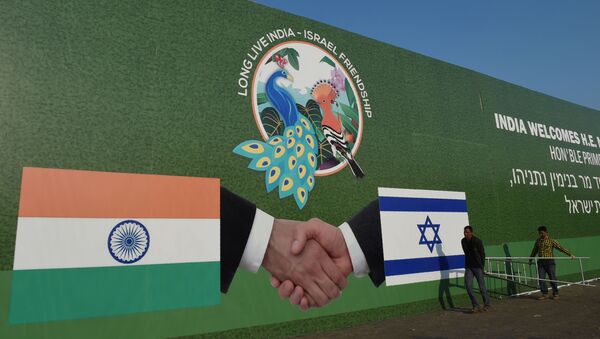 Indian workers hang a billboard bearing the national flags of Israel and India in Ahmedabad on January 16, 2018 - Sputnik International
