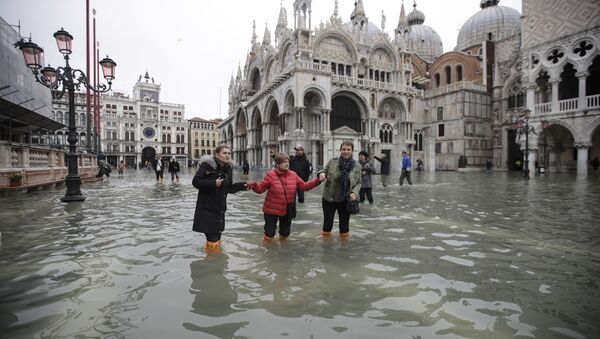 People wade through water in a flooded St. Mark's Square in Venice, Italy, Wednesday, Nov. 13, 2019 - Sputnik International