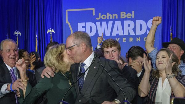 Louisiana Gov. John Bel Edwards celebrates with his wife Donna Edwards as he arrives to address supporters at his election night watch party in Baton Rouge, La., Saturday, Nov. 16, 2019 - Sputnik International