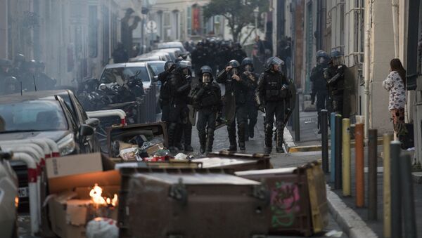 Police approach a barricade made by protesters during a yellow vest demonstration marking the one year anniversary of the movement in Marseille, southern France, Saturday, Nov. 16, 2019.  Police are deployed around key sites in Paris as France's yellow vest protesters prepare to mark the first anniversary of their sometimes-violent movement for economic justice. - Sputnik International