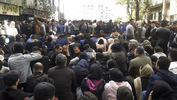 Protestors attend a demonstration after authorities raised petrol prices, in the northern city of Sari, Iran, Saturday, 16 Nov 2019. Protesters angered by Iran raising government-set petrol prices by 50% blocked traffic in major cities and occasionally clashed with police Saturday after a night of demonstrations punctuated by gunfire. - Sputnik International