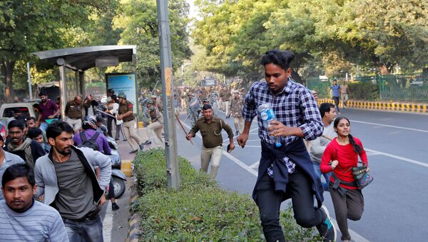 Police wield their batons against students of Jawaharlal Nehru University (JNU) during a protest against a proposed fee hike, in New Delhi, India, November 18, 2019 - Sputnik International