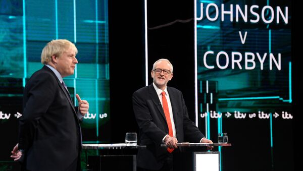 Conservative leader Boris Johnson and Labour leader Jeremy Corbyn are seen during a televised debate ahead of general election in London, Britain, November 19, 2019. - Sputnik International