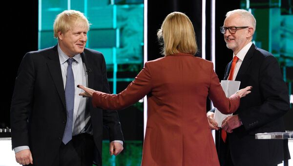 Conservative leader Boris Johnson and Labour leader Jeremy Corbyn are seen during a televised debate ahead of general election in London, Britain, November 19, 2019 - Sputnik International