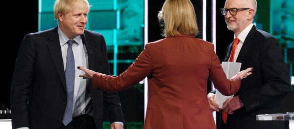 Conservative leader Boris Johnson and Labour leader Jeremy Corbyn are seen during a televised debate ahead of general election in London, Britain, November 19, 2019 - Sputnik International