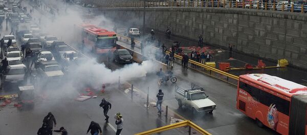 Riot police tries to disperse people as they protest on a highway against increased gas price in Tehran, Iran November 16, 2019 - Sputnik International