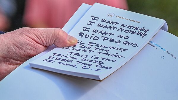 U.S. President Donald Trump holds what appears to be a prepared statement and handwritten notes after watching testimony by U.S. Ambassador to the European Union Gordon Sondland as he speaks to reporters prior to departing for travel to Austin, Texas from the South Lawn of the White House in Washington, U.S., November 20, 2019 - Sputnik International