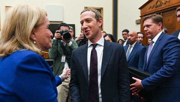 Facebook Chairman and CEO Mark Zuckerberg greets Rep. Sylvia Garcia (D-TX) after testifying at a House Financial Services Committee hearing in Washington, U.S., October 23, 2019 - Sputnik International