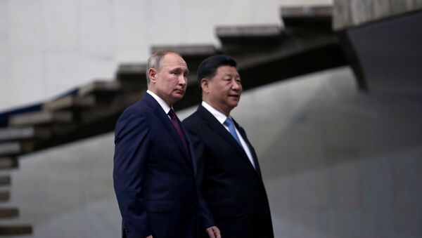 Russia's President Vladimir Putin and China's Xi Jinping walk down the stairs as they arrive for the BRICS summit in Brasilia, Brazil, 14 November 2019. - Sputnik International