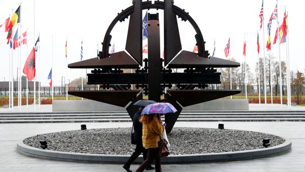 People hold umbrellas outside NATO headquarters in Brussels, Belgium, November 26, 2019 - Sputnik International