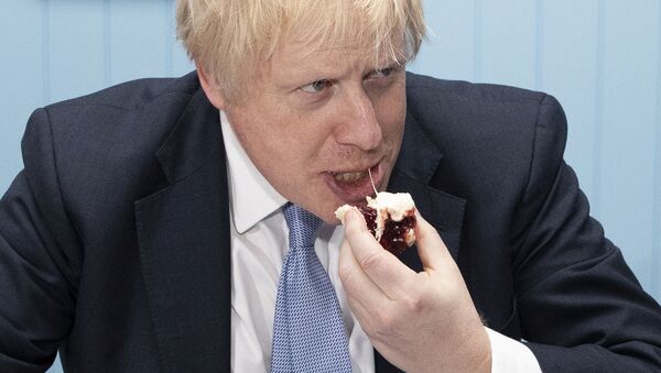 Britain's Prime Minister Boris Johnson enjoys a cream tea while touring 'Rodda's Clotted Cream', in Redruth, Britain November 27, 2019 - Sputnik International