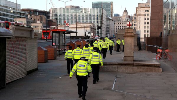 Police officers walk near the scene of a stabbing on London Bridge - Sputnik International