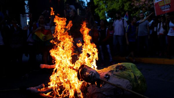 An effigy depicting U.S. President, Donald Trump is set on fire by supporters of Bolivia's ousted President Evo Morales outside the U.S. embassy in Buenos Aires  - Sputnik International