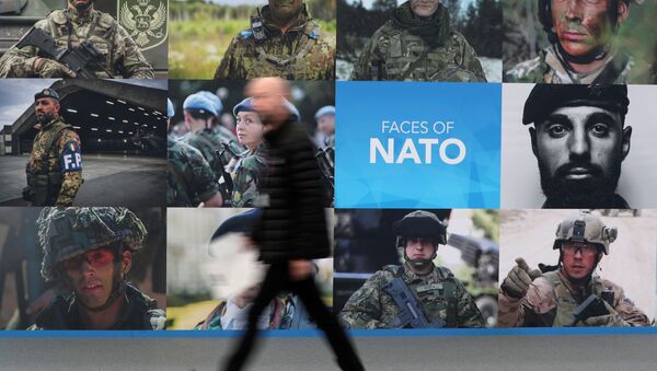 A man walks past a NATO sign ahead of a NATO leaders summit at the Grove in Watford, Britain December 3, 2019 - Sputnik International