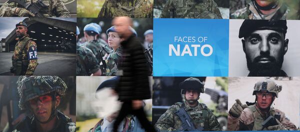 A man walks past a NATO sign ahead of a NATO leaders summit at the Grove in Watford, Britain December 3, 2019 - Sputnik International