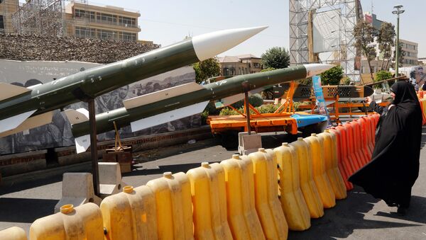 An Iranian woman looks at Taer-2 missile during a street exhibition by Iran's army and paramilitary Revolutionary Guard celebrating  Defence Week marking the 39th anniversary of the start of 1980-88 Iran-Iraq war, at the Baharestan Square in Tehran, on September 26, 2019 - Sputnik International
