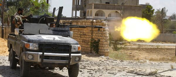 A fighter loyal to the internationally recognised Libyan Government of National Accord (GNA) fires a truck-mounted gun during clashes with forces loyal to strongman Khalifa Haftar in the capital Tripoli's suburb of Ain Zara, on September 7, 2019. - Sputnik International