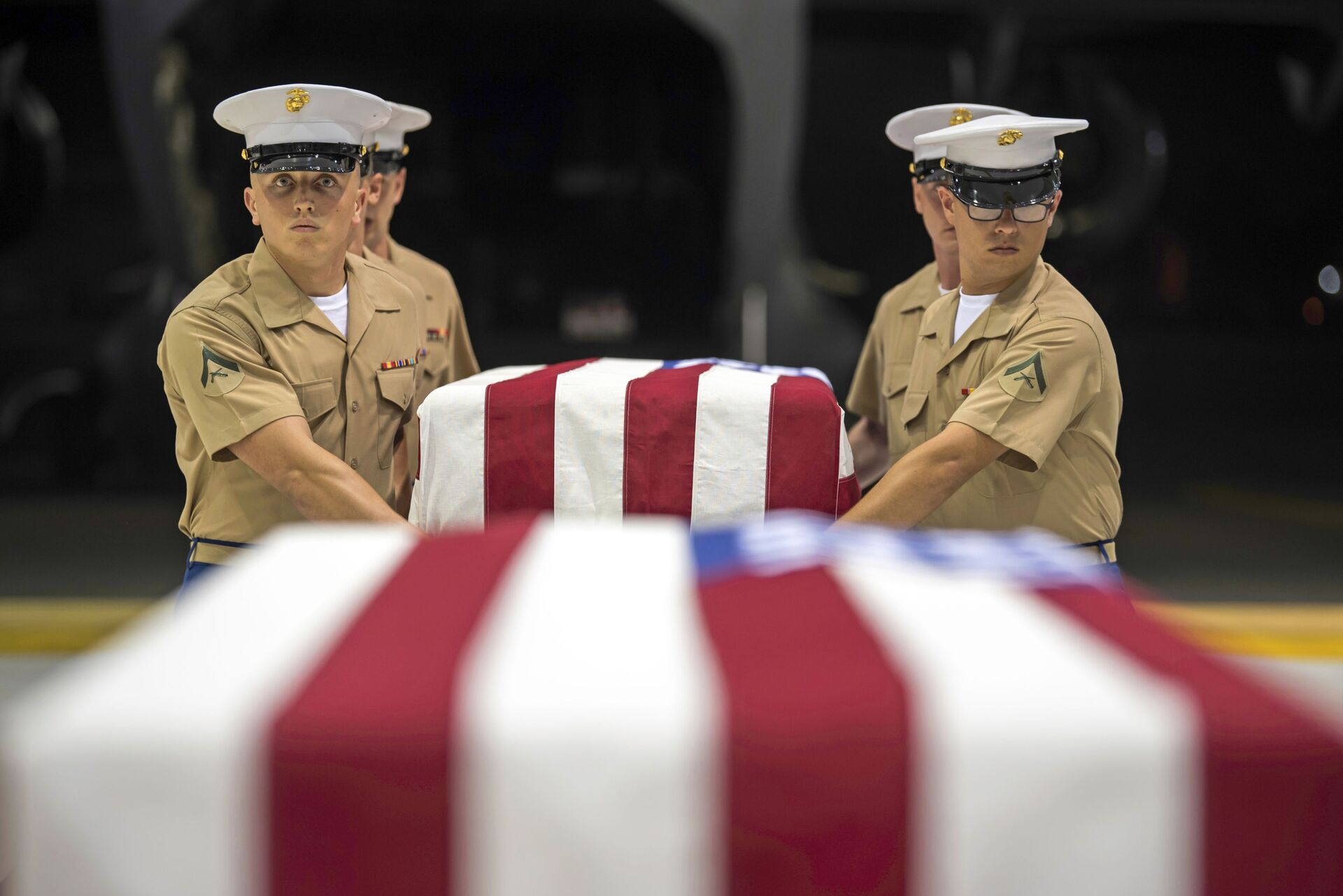 In this Wednesday, July 17, 2019 photo, US Marines carry transfer cases holding the possible remains of unidentified service members lost in the Battle of Tarawa during World War II, during what is known as an honorable carry conducted by the Defense POW/MIA Accounting Agency (DPAA), in a hangar at Joint Base Pearl Harbor-Hickam in Hawaii. - Sputnik International, 1920, 24.05.2023