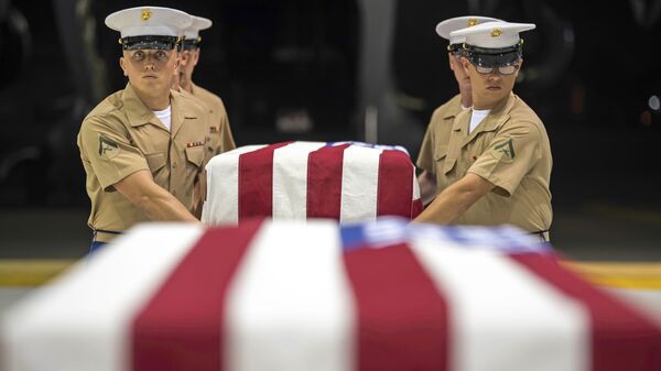 In this Wednesday, 17 July 2019 photo, US Marines carry transfer cases holding the possible remains of unidentified service members lost in the Battle of Tarawa during World War II, during what is known as an honourable carry conducted by the Defense POW/MIA Accounting Agency (DPAA), in a hangar at the Joint Base Pearl Harbor-Hickam in Hawaii. - Sputnik International
