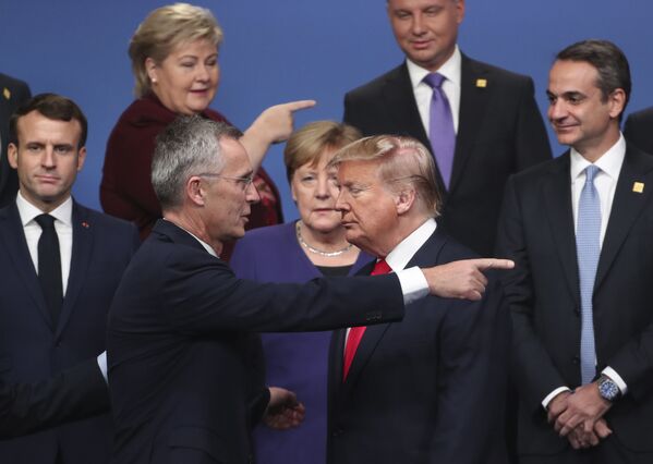 NATO Secretary General Jens Stoltenberg, center front left, speaks with U.S. President Donald Trump, center front right, after a group photo at a NATO leaders meeting at The Grove hotel and resort in Watford, Hertfordshire, England, Wednesday, Dec. 4, 2019. - Sputnik International