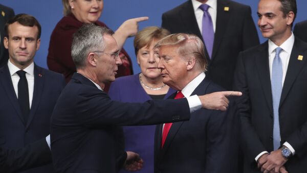 NATO Secretary General Jens Stoltenberg, center front left, speaks with U.S. President Donald Trump, center front right, after a group photo at a NATO leaders meeting at The Grove hotel and resort in Watford, Hertfordshire, England, Wednesday, Dec. 4, 2019. - Sputnik International