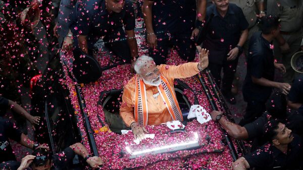 India's Prime Minister Narendra Modi waves towards his supporters during a roadshow in Varanasi, India, April 25, 2019 - Sputnik International