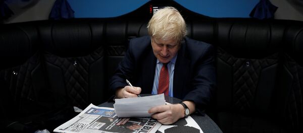Britain's Prime Minister Boris Johnson works inside his campaign bus in Kent, Britain, December 6, 2019.  - Sputnik International