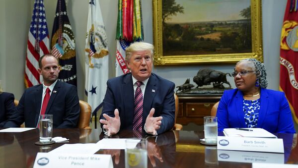 President Donald Trump speaks while sitting between Ryan Newby, Vice President of the Bank of Laverne and Barb Smith, the President of  Journey Steel, while participating in a roundtable on small business and red tape reduction accomplishments in the Roosevelt Room at the White House in Washington, U.S. December 6, 2019.  - Sputnik International