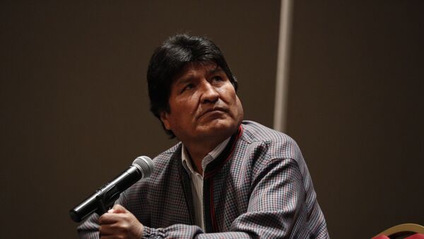 Former Bolivian President Evo Morales, who was granted asylum in Mexico, looks up toward a video playing on a screen during a press conference in Mexico City, Wednesday, Nov. 20, 2019.  - Sputnik International