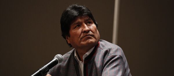 Former Bolivian President Evo Morales, who was granted asylum in Mexico, looks up toward a video playing on a screen during a press conference in Mexico City, Wednesday, Nov. 20, 2019.  - Sputnik International