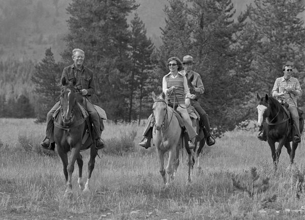 President Jimmy Carter and his wife, Rosalynn, guide their horses towards the corral after a day of horseback riding near Jenny Lake in Wyoming, Aug. 30, 1978 - Sputnik International