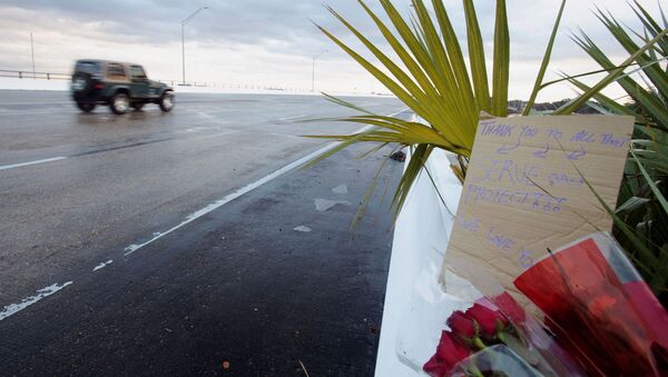 Flowers and a message are left on the entrance bridge after a member of the Saudi Air Force visiting the United States for military training was the suspect in a shooting at Naval Air Station Pensacola, in Pensacola, Florida, U.S. December 6, 2019. - Sputnik International