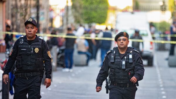 Police officers guard a crime scene where four people were killed and two injured in a shooting near Mexico's National Palace, the presidential residence in the capital's historic downtown, officials said, in Mexico City, Mexico December 7, 2019. - Sputnik International