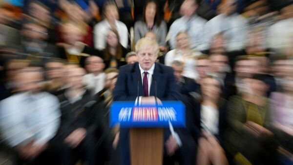 Britain's Prime Minister Boris Johnson speaks to the workers as he visits a JCB factory during his general election campaign in Uttoxeter, Britain, December 10, 2019. Picture taken with a zoom burst. REUTERS/Toby Melville - Sputnik International