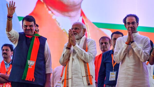 India's Prime Minister Narendra Modi (C) gestures along with Hindu right-wing party Shiv Sena Chief Uddhav Thackeray (R) and Chief Minister of the state Devendra Fadnavis (L) as they attend a public rally in the run up to the Maharashtra state assembly elections, in Mumbai on October 18, 2019 - Sputnik International